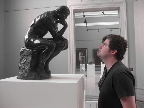 man looking at the thinker